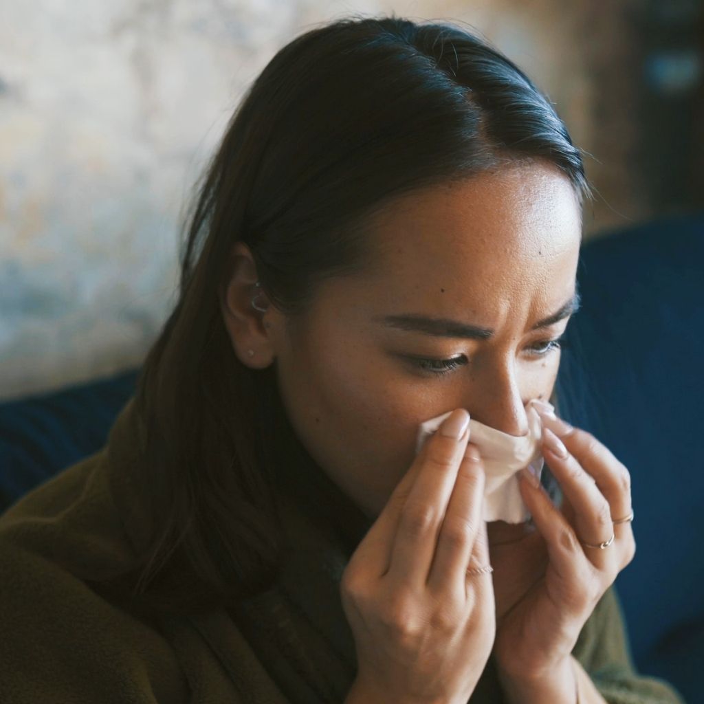Person experiencing nasal congestion before ayurvedic treatment for nasal congestion